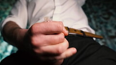 Sexy guy in a suit jerks off close-up, moans with pleasure and cums in a condom. Thumb