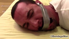 Victor SockGagged and TapeGagged tight and captured with socks inside his mouth wrapped the tape aro Thumb